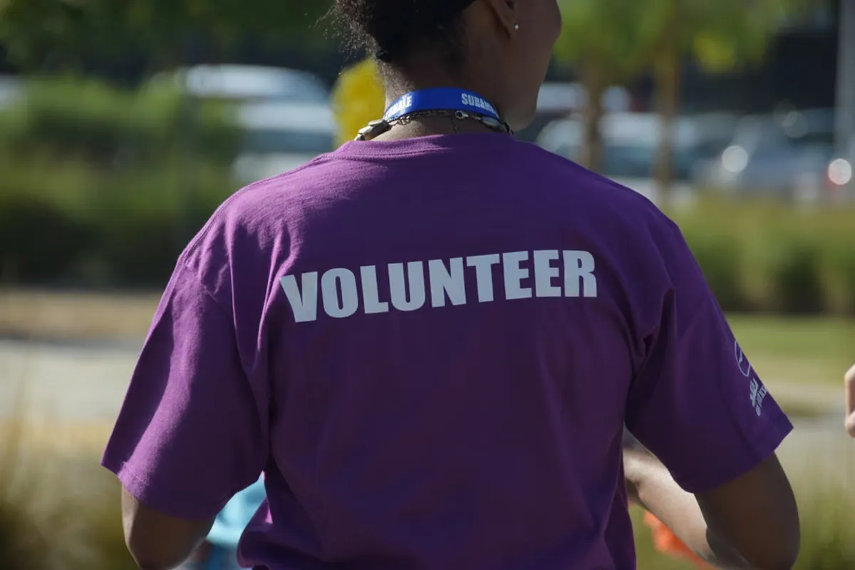 Volunteer wearing a volunteer shirt